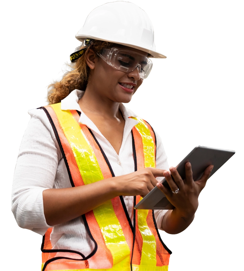 Female worker with safety vest and hard hat looking at a tablet